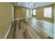 Spacious main bedroom with tray ceiling, ceiling fan, laminate flooring, and ensuite bathroom at 1960 Banks Way, Atlanta, GA 30349