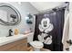 Charming bathroom with modern sink, toilet, and Mickey Mouse themed shower curtain at 2172 Oakland Ridge Dr, Lawrenceville, GA 30044