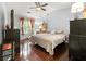 Serene bedroom with hardwood floors, ceiling fan, and ample natural light from the large window at 2172 Oakland Ridge Dr, Lawrenceville, GA 30044