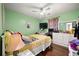 Bright bedroom with ceiling fan, hardwood floors, desk area and a large dresser at 2172 Oakland Ridge Dr, Lawrenceville, GA 30044