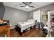 This bedroom offers hardwood floors, a ceiling fan and natural light at 2172 Oakland Ridge Dr, Lawrenceville, GA 30044