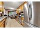 Well-lit kitchen featuring stainless steel appliances, wood cabinets, and a view into the dining area at 2172 Oakland Ridge Dr, Lawrenceville, GA 30044