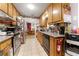 Functional kitchen with wood cabinets, stainless steel appliances, and convenient access to the dining area at 2172 Oakland Ridge Dr, Lawrenceville, GA 30044