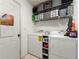 Efficient laundry room with washer, dryer, storage shelves and tile flooring at 2172 Oakland Ridge Dr, Lawrenceville, GA 30044