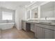 Contemporary bathroom with double sinks, granite countertops, and an elegant freestanding tub at 342 Overlook Rd, Covington, GA 30014