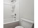 Shower/tub combination with brushed silver shower head and white porcelain toilet at 342 Overlook Rd, Covington, GA 30014