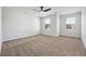 Spacious bedroom with carpeted floors, ceiling fan, and natural light from the windows at 342 Overlook Rd, Covington, GA 30014
