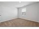 Simple bedroom featuring neutral carpet and a window overlooking the neighborhood at 342 Overlook Rd, Covington, GA 30014
