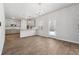 Open dining area with wood-look floors, chandelier and access to the kitchen, seamlessly blending style and functionality for modern living at 342 Overlook Rd, Covington, GA 30014