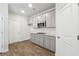 Well-appointed kitchen with gray cabinets, modern appliances, subway tile backsplash and wood-look floors, offering style and functionality at 342 Overlook Rd, Covington, GA 30014