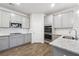 Modern kitchen with gray cabinetry, granite countertops, stainless steel appliances, and wood-look floors for a sleek, functional design at 342 Overlook Rd, Covington, GA 30014