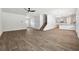 Open-concept living area with wood-look floors connecting the living room, staircase, kitchen, and dining area for seamless living at 342 Overlook Rd, Covington, GA 30014