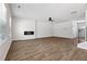 Cozy living room with wood-look floors, fireplace, and large windows, creating a warm and inviting atmosphere with natural light at 342 Overlook Rd, Covington, GA 30014