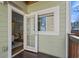 Exterior view of a wooden balcony with an open glass door leading into the home's interior at 735 Ponce De Leon Pl Ne Unit 1, Atlanta, GA 30306