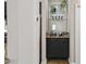 Stylish butler pantry with glass shelving, granite countertop, and modern cabinetry at 735 Ponce De Leon Pl Ne Unit 1, Atlanta, GA 30306