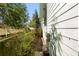 The house is a light gray color with a narrow side yard and tall wooden fence at 735 Ponce De Leon Pl Ne Unit 1, Atlanta, GA 30306