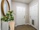 Bright foyer featuring a white door, coat closet, wood floors, and a round mirror at 735 Ponce De Leon Pl Ne Unit 1, Atlanta, GA 30306