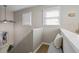 Bright hallway with a gray bench, white railing, neutral walls, and two windows with blinds at 735 Ponce De Leon Pl Ne Unit 1, Atlanta, GA 30306