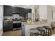 Contemporary kitchen featuring granite countertops, breakfast bar, stylish backsplash, and stainless steel appliances at 735 Ponce De Leon Pl Ne Unit 1, Atlanta, GA 30306