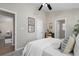 This is a bedroom featuring a king size bed, neutral walls, a ceiling fan, and three doors at 735 Ponce De Leon Pl Ne Unit 1, Atlanta, GA 30306