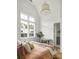 Bright bedroom with large windows, neutral tones, and a view of neighboring buildings at 1126 Mado Loop, Chattahoochee Hills, GA 30268