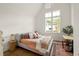 Bedroom featuring vaulted ceilings and large windows with neighborhood views at 1126 Mado Loop, Chattahoochee Hills, GA 30268