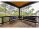Relaxing covered porch with wooded views and comfortable seating at 1126 Mado Loop, Chattahoochee Hills, GA 30268