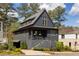 Charming two-story home with a covered porch, gray siding, and metal roof at 1126 Mado Loop, Chattahoochee Hills, GA 30268