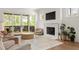 Cozy living room with a fireplace, access to an outdoor patio, and a comfortable seating area at 1126 Mado Loop, Chattahoochee Hills, GA 30268