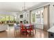 Open-concept dining and living area with bright lighting and access to a outdoor deck at 1126 Mado Loop, Chattahoochee Hills, GA 30268