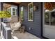 Inviting porch features a hanging chair and hanging plants creating a cozy outdoor space at 1126 Mado Loop, Chattahoochee Hills, GA 30268