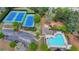 Aerial view of community with tennis courts, swimming pool and playground surrounded by lush landscaping at 335 Wyehwood Ct, Alpharetta, GA 30022