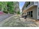 Spacious backyard featuring stone patio with outdoor dining set and lush landscaping at 335 Wyehwood Ct, Alpharetta, GA 30022