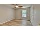 Bedroom features a ceiling fan, hardwood floors, and a large window at 335 Wyehwood Ct, Alpharetta, GA 30022