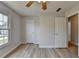Bedroom featuring wood flooring, a ceiling fan, natural light from window, and entry to closet at 335 Wyehwood Ct, Alpharetta, GA 30022