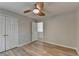 Empty bedroom features a ceiling fan, hardwood floors, and double doors at 335 Wyehwood Ct, Alpharetta, GA 30022