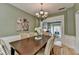 Elegant dining room with chandelier opens to living area, perfect for entertaining at 335 Wyehwood Ct, Alpharetta, GA 30022