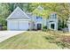 Beautiful home showcasing a two-car garage, lush lawn, and well-maintained landscape at 335 Wyehwood Ct, Alpharetta, GA 30022