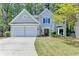 Charming home featuring a two-car garage, manicured lawn, and beautiful landscaping at 335 Wyehwood Ct, Alpharetta, GA 30022