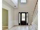 Welcoming foyer with high ceilings, wood floors, and a view of the front door with glass accents at 335 Wyehwood Ct, Alpharetta, GA 30022
