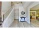 Bright foyer featuring wood floors, a staircase, and an open doorway to a connected room at 335 Wyehwood Ct, Alpharetta, GA 30022