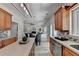 Open kitchen with island and stainless appliances flows into breakfast nook and Gathering room at 335 Wyehwood Ct, Alpharetta, GA 30022