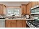 Bright kitchen featuring wood cabinets, stainless appliances, and a decorative tile backsplash at 335 Wyehwood Ct, Alpharetta, GA 30022