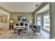 Comfortable living room featuring light-green walls, wood floors, and a large window for natural light at 335 Wyehwood Ct, Alpharetta, GA 30022
