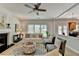 Comfortable living room with fireplace, ceiling fan, hardwood floors, and view of kitchen and backyard at 335 Wyehwood Ct, Alpharetta, GA 30022