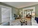 Serene living room showcasing an open view to the foyer and dining room, plus neutral colors and wood floors at 335 Wyehwood Ct, Alpharetta, GA 30022