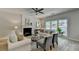 Bright and airy living room featuring a fireplace, ceiling fan, and plenty of natural light from large windows at 335 Wyehwood Ct, Alpharetta, GA 30022