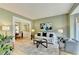Inviting living room with a view of the dining area, light-green walls, and wood floors at 335 Wyehwood Ct, Alpharetta, GA 30022