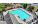 A community pool with lounge chairs, umbrellas, and a shaded pergola for residents to enjoy at 335 Wyehwood Ct, Alpharetta, GA 30022