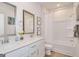 Bright bathroom features dual sinks, modern fixtures, and a bathtub with shower at 505 Altamaha Court, Locust Grove, GA 30248